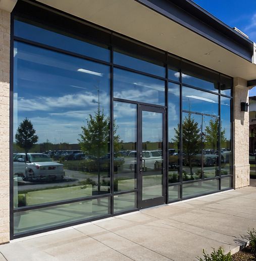 Modern commercial shopfront with full-height glazing and dark frames